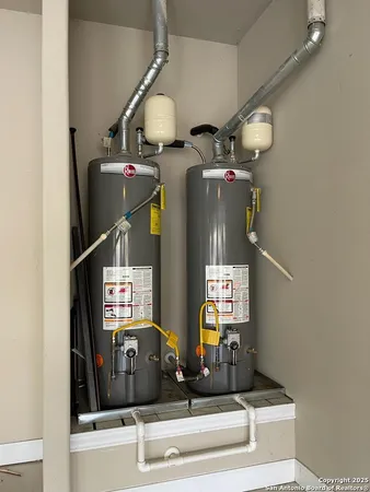 a kitchen with stainless steel appliances white cabinets and a refrigerator