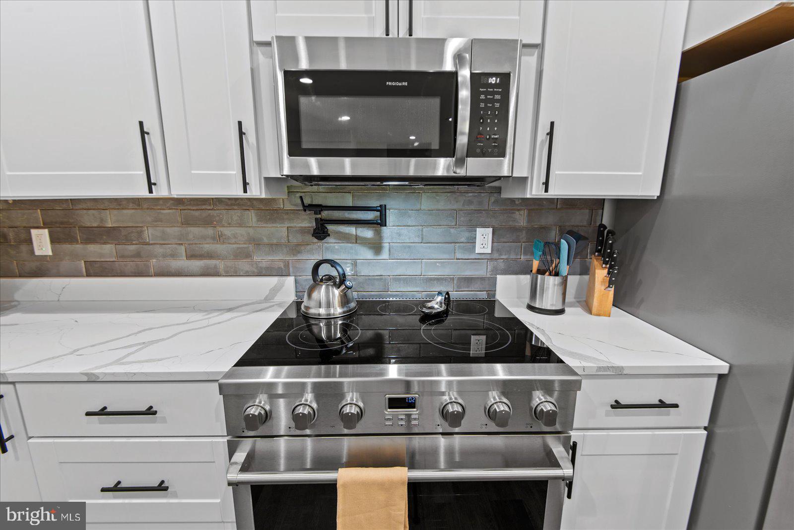 7206 Castaway Beach Road Orange, VA 22960 - Photo 21 of 64 White kitchen with stainless appliances