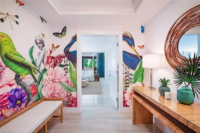 a living room with furniture and flowers