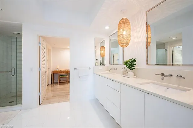 a spacious bathroom with a sink a mirror and a shower