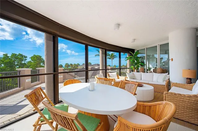 a dining room with furniture water view and a garden