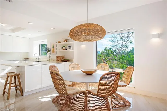 a dining room with furniture and a large window