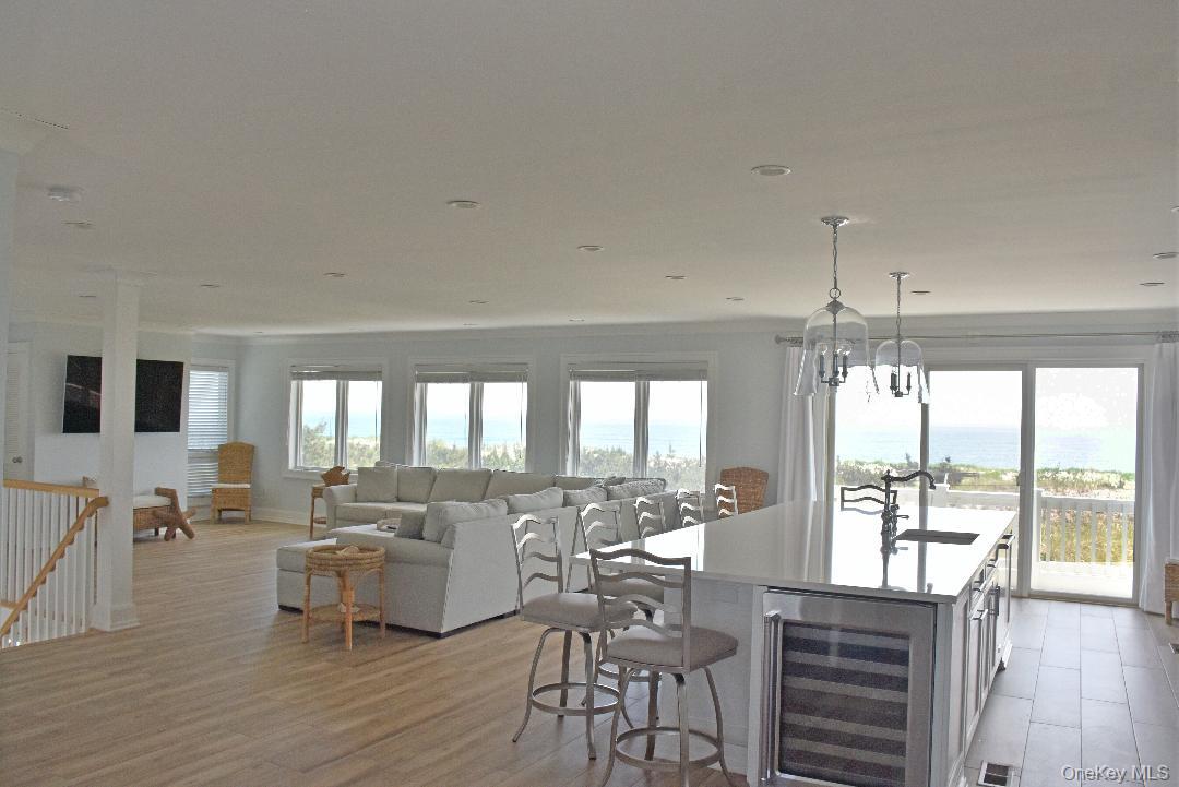 561 Dune Road Westhampton, NY 11978 - Photo 4 of 8 a view of a dining room with furniture window and wooden floor