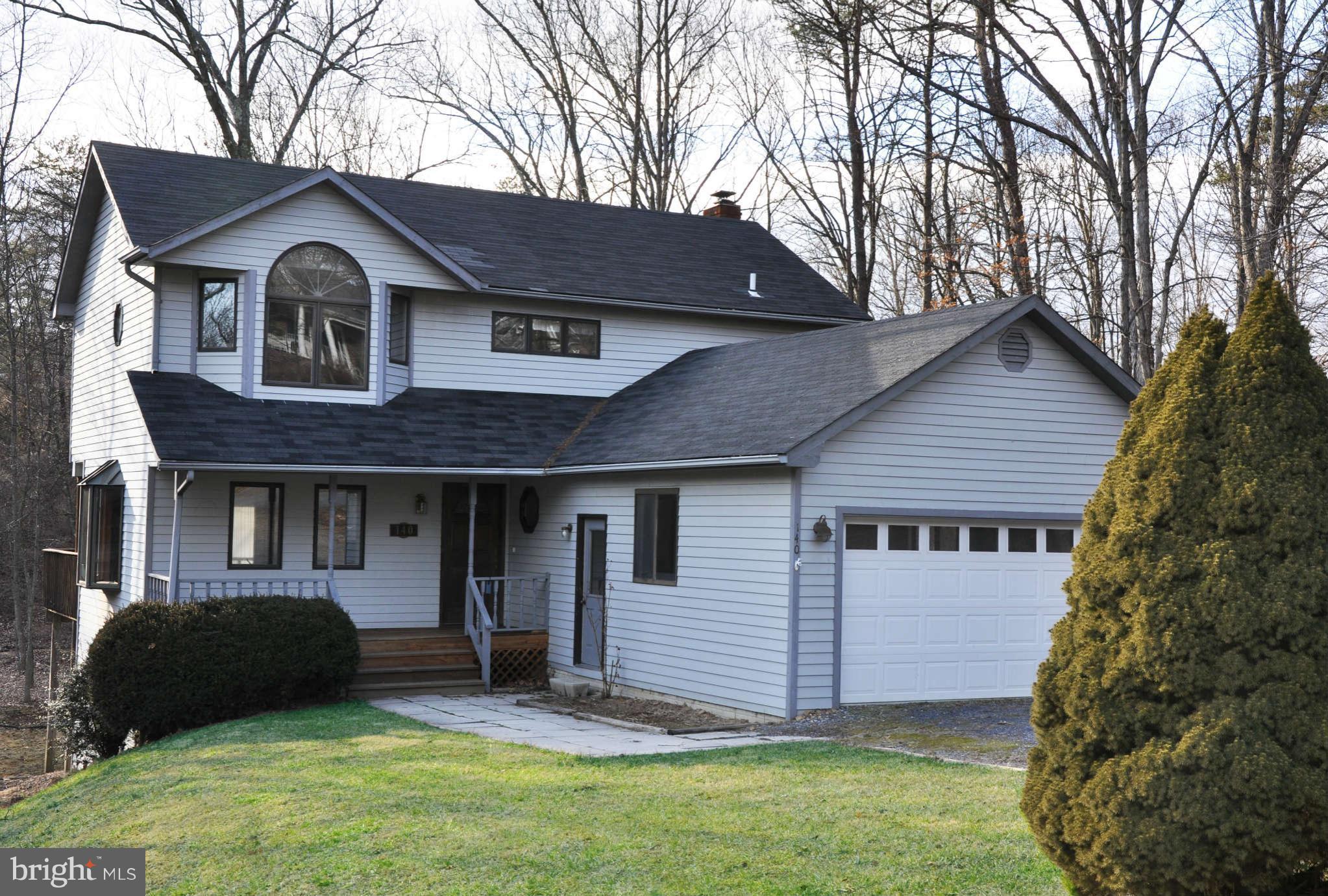 140 Holiday Road Cross Junction, VA 22625 - Photo 1 of 30 a house that has a tree in front of the house