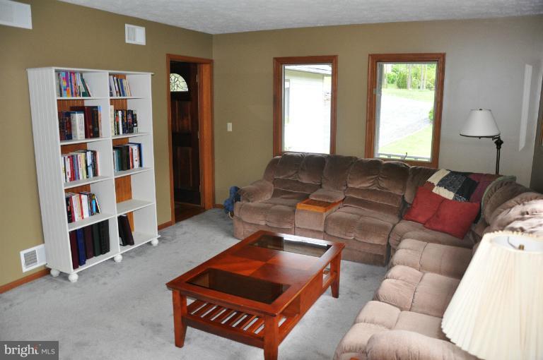 140 Holiday Road Cross Junction, VA 22625 - Photo 12 of 30 a living room with furniture and a book shelf