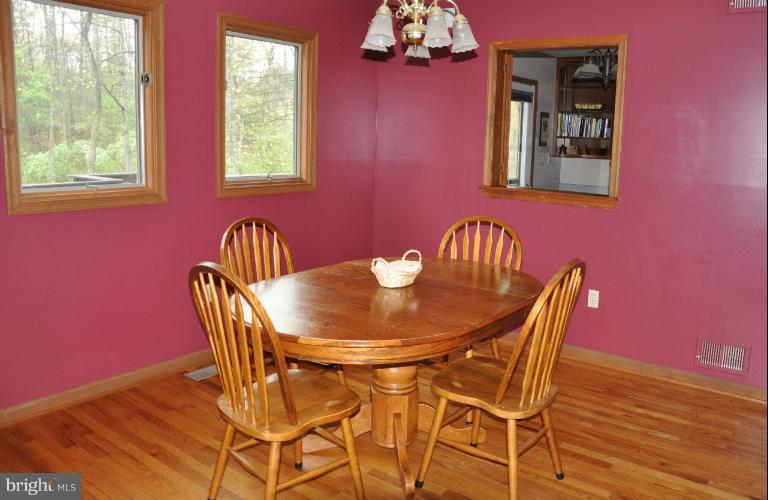 140 Holiday Road Cross Junction, VA 22625 - Photo 13 of 30 a view of a dining room with furniture and chandelier