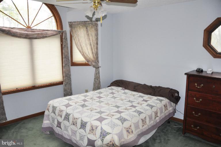 140 Holiday Road Cross Junction, VA 22625 - Photo 17 of 30 a bedroom with a bed and a window