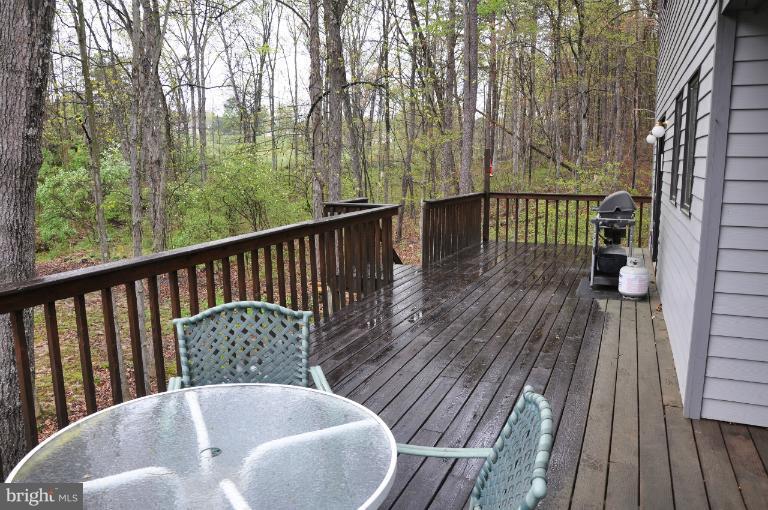 140 Holiday Road Cross Junction, VA 22625 - Photo 5 of 30 a balcony with wooden floor table and chairs