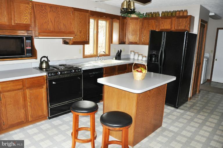 140 Holiday Road Cross Junction, VA 22625 - Photo 8 of 30 a kitchen with stainless steel appliances granite countertop a sink stove and refrigerator