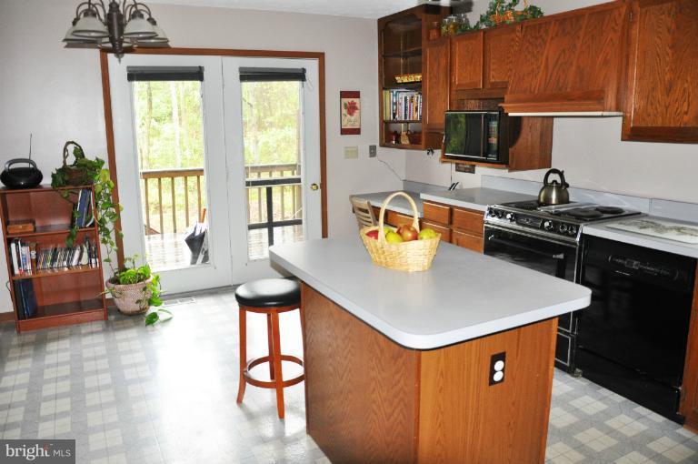 140 Holiday Road Cross Junction, VA 22625 - Photo 9 of 30 a kitchen with a sink a stove and chairs