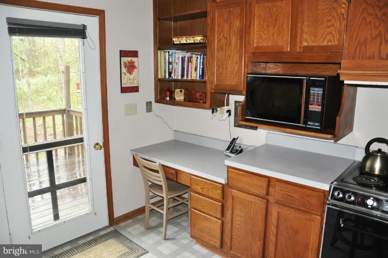 140 Holiday Road Cross Junction, VA 22625 - Photo 10 of 30 a kitchen with a cabinets and a stove top oven