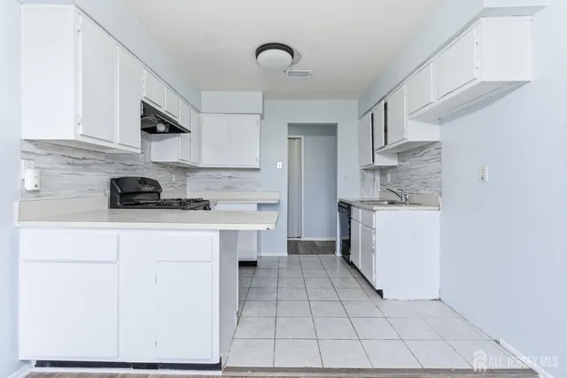 a kitchen with stainless steel appliances granite countertop a sink and cabinets