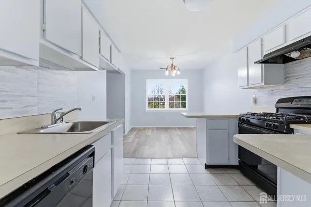 a view of a room with wooden floor and windows