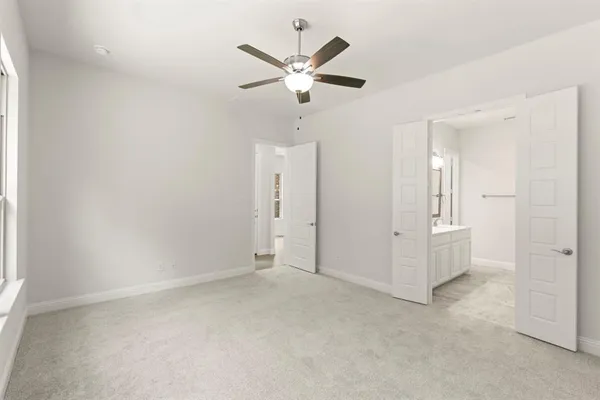 an empty room with closet and windows