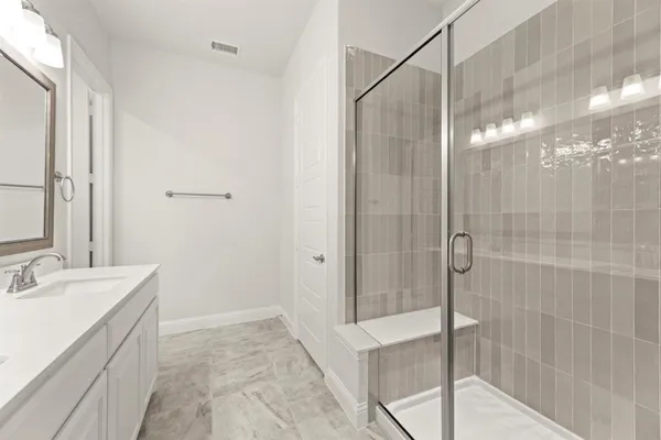 a bathroom with a shower and a sink
