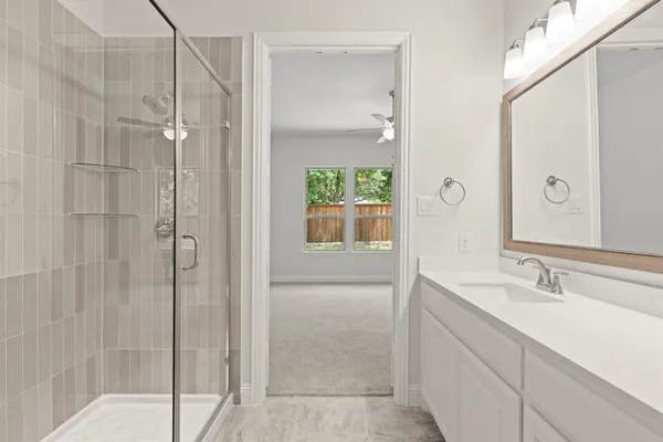 a bathroom with a shower and a sink