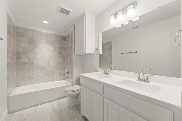 a bathroom with a sink a toilet and a large mirror