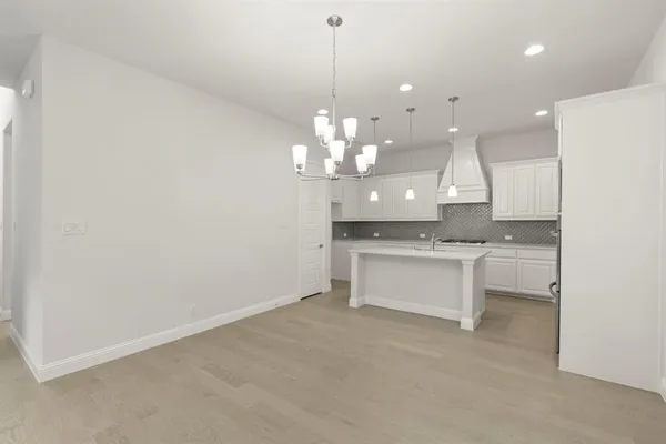 a view of a kitchen with a sink and chandelier