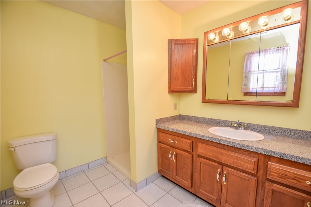 5050 Canfield Road Canfield, OH 44406 - Photo 23 of 47 Bathroom featuring toilet, tile flooring, and oversized vanity