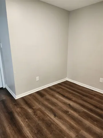 a view of a house with backyard and wooden fence