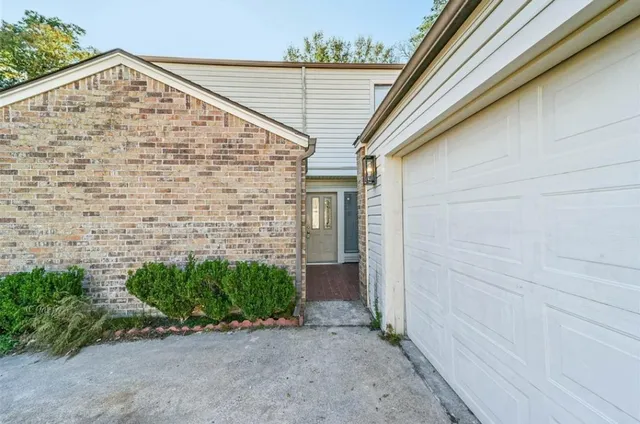 an empty room with wooden floor fan and window
