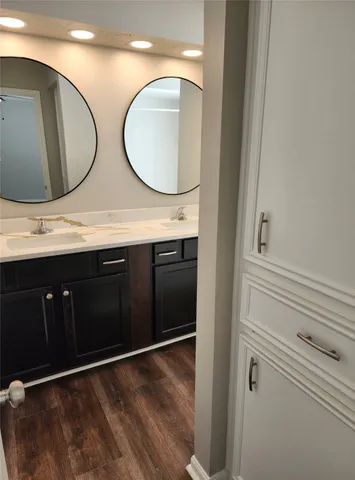 a kitchen with white cabinets stainless steel appliances and sink