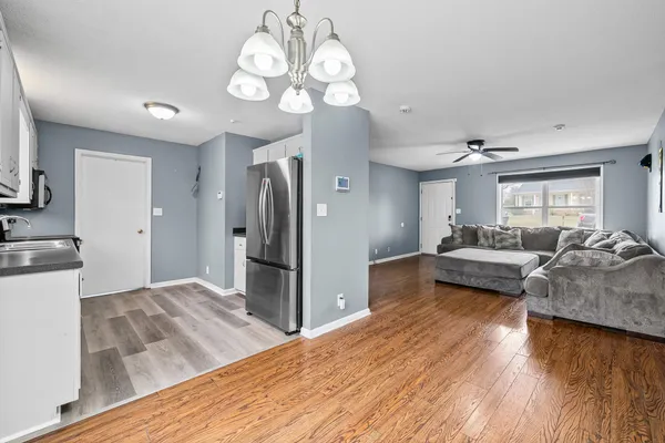 a living room with furniture and a chandelier