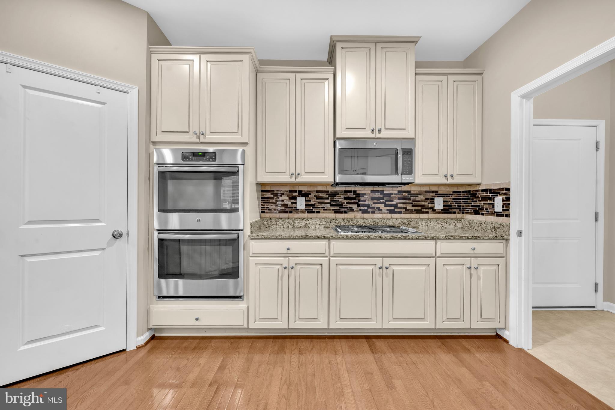 41663 McMonagle Square Aldie, VA 20105 - Photo 13 of 50 a kitchen with stainless steel appliances granite countertop a refrigerator and white cabinets
