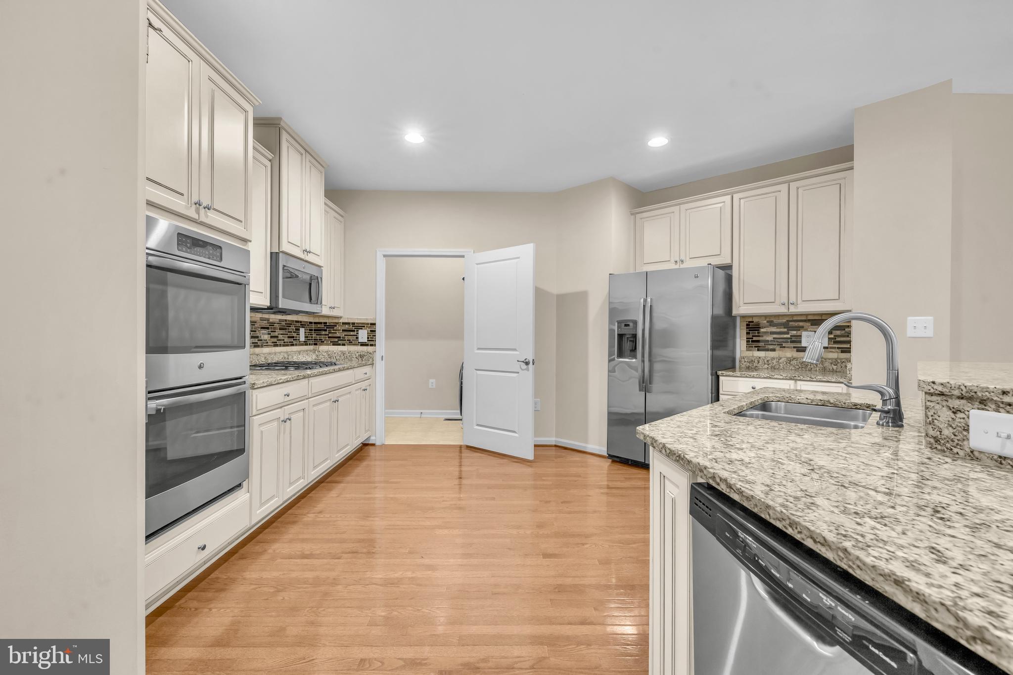 41663 McMonagle Square Aldie, VA 20105 - Photo 14 of 50 a kitchen with granite countertop a refrigerator and a sink