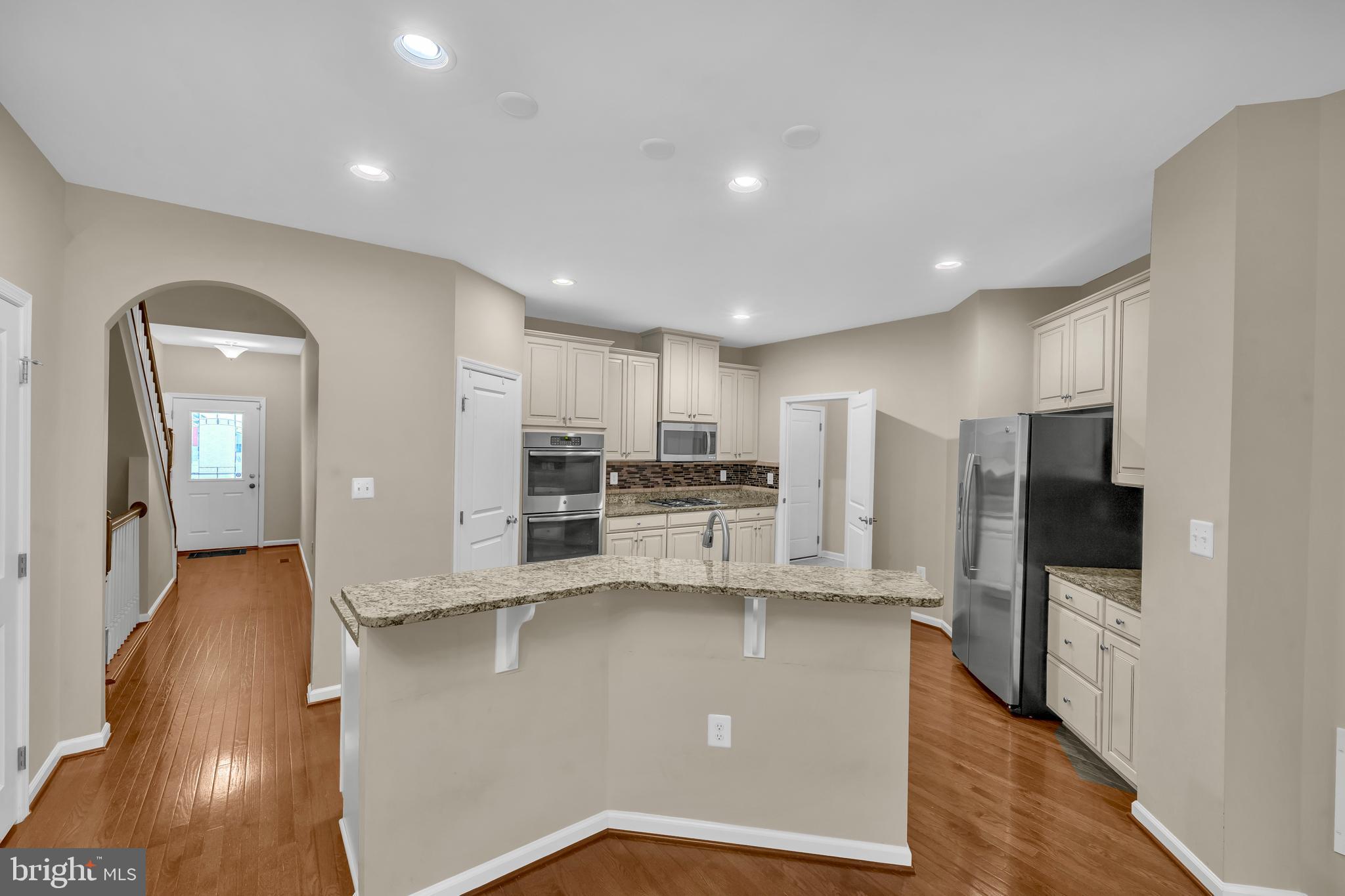 41663 McMonagle Square Aldie, VA 20105 - Photo 15 of 50 a large kitchen with stainless steel appliances a refrigerator and a stove top oven