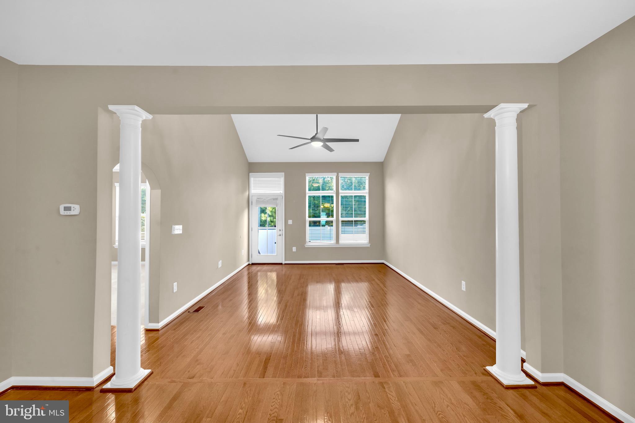 41663 McMonagle Square Aldie, VA 20105 - Photo 18 of 50 a view of an empty room with wooden floor and a window