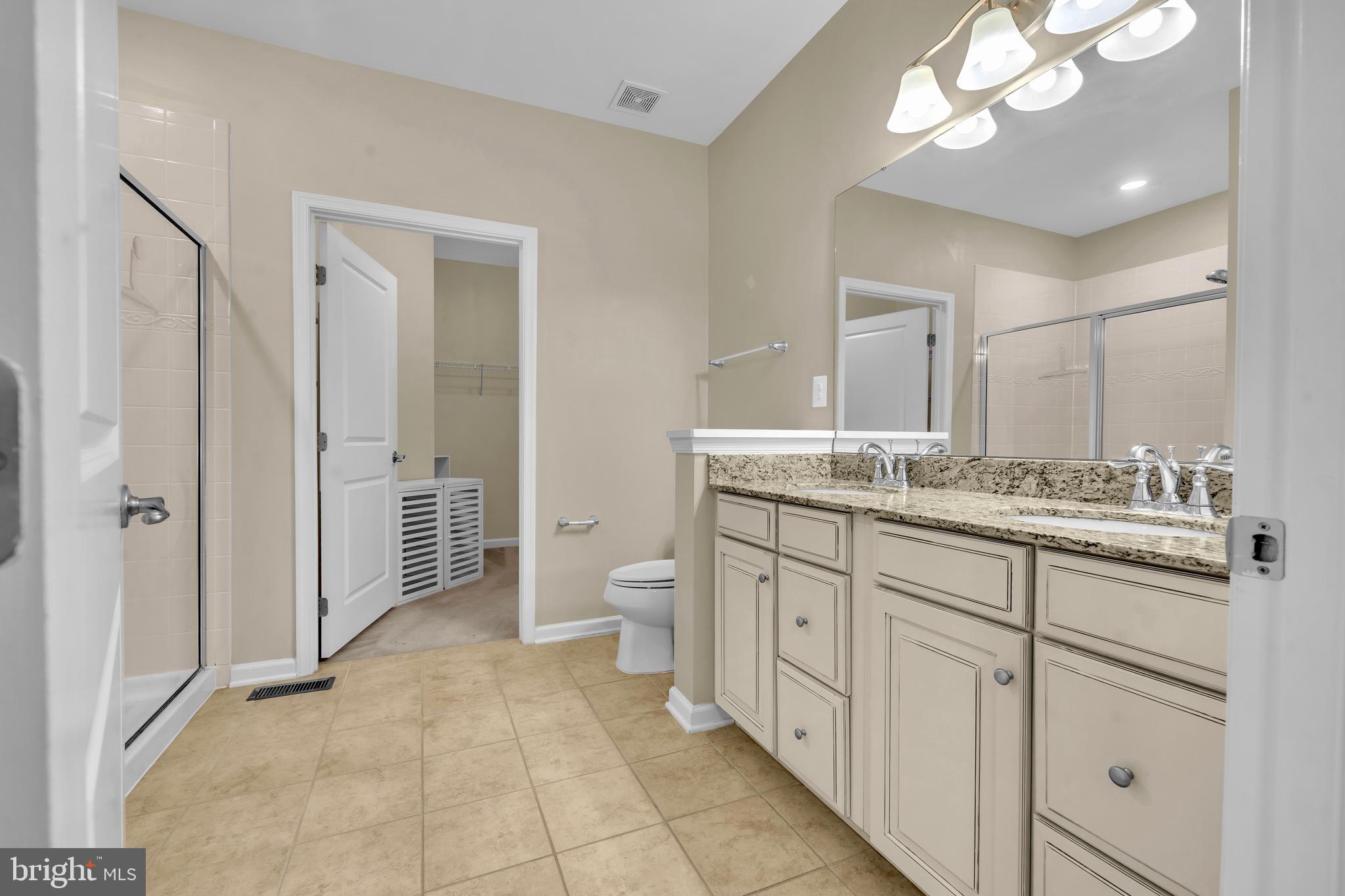 41663 McMonagle Square Aldie, VA 20105 - Photo 21 of 50 a spacious bathroom with a granite countertop sink mirror and a