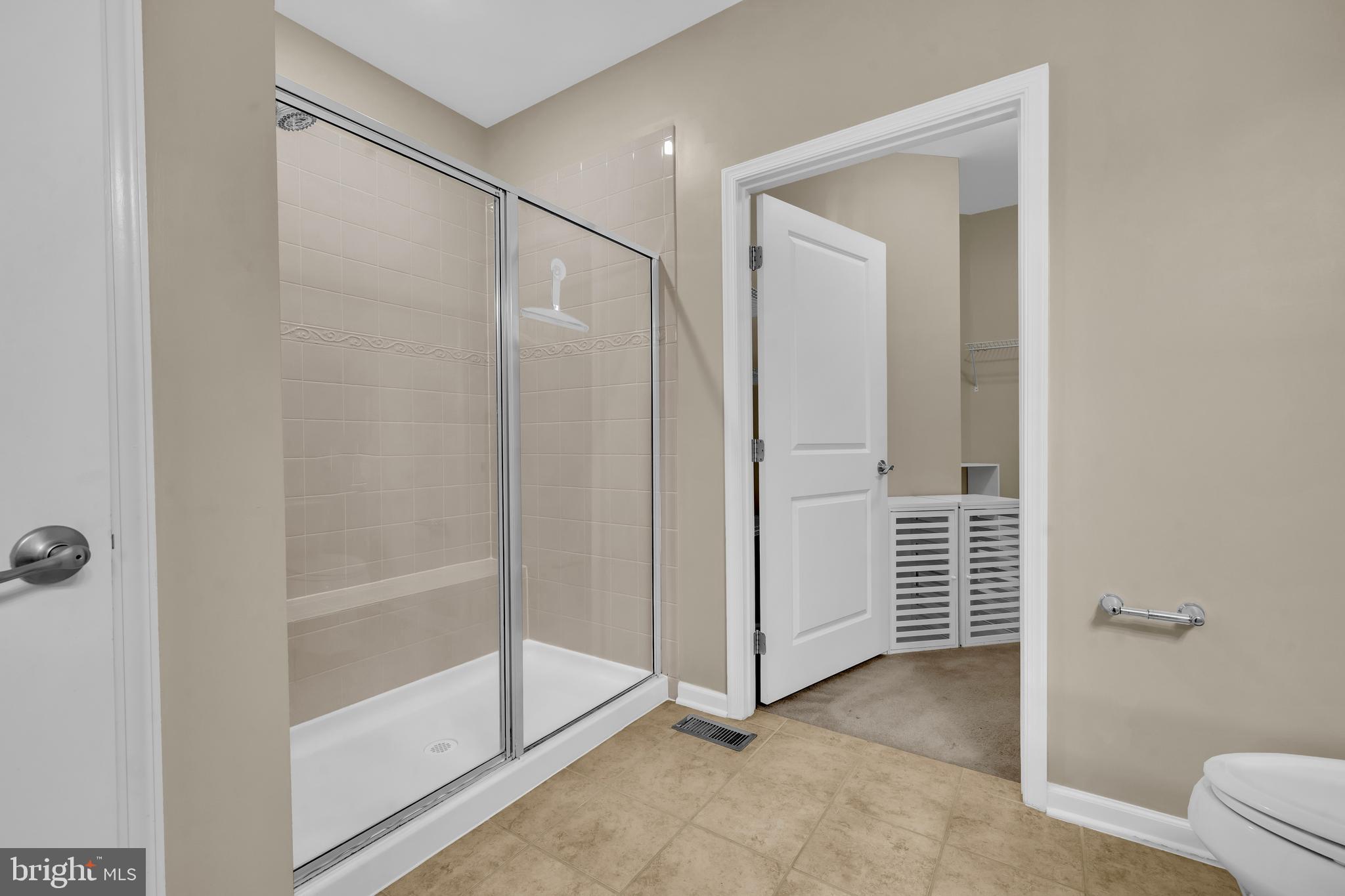 41663 McMonagle Square Aldie, VA 20105 - Photo 22 of 50 a bathroom with a shower and a glass door