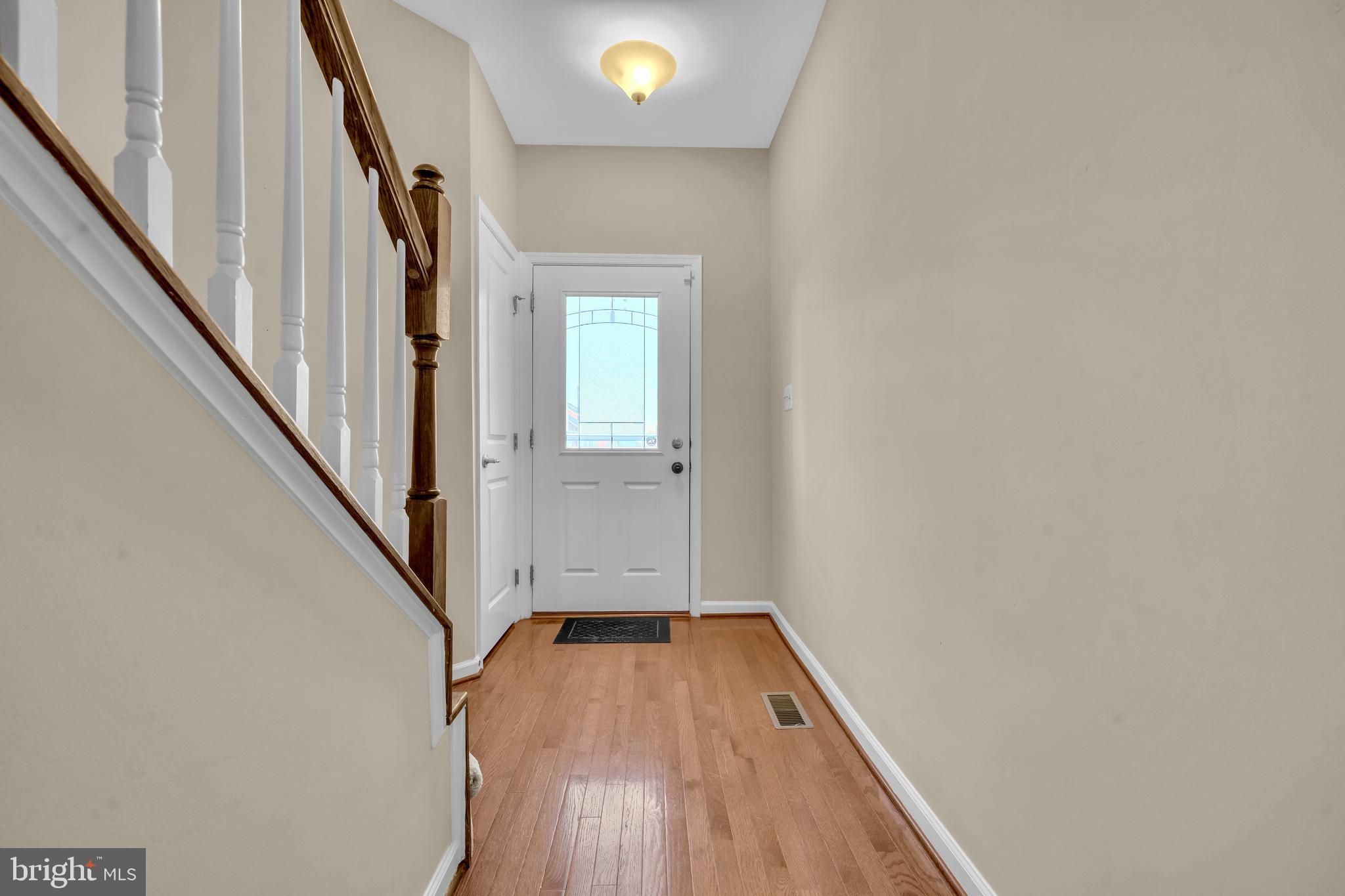 41663 McMonagle Square Aldie, VA 20105 - Photo 3 of 50 a view of a hallway with wooden floor and staircase