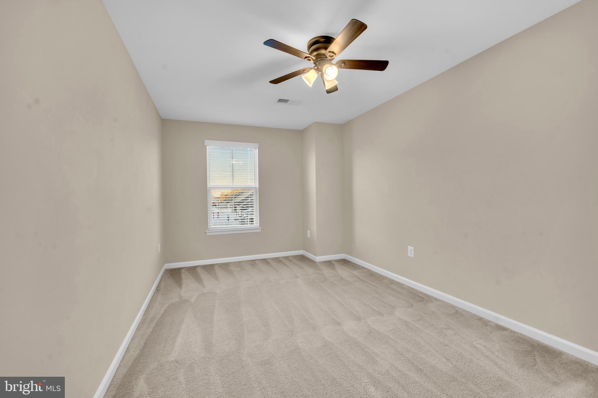41663 McMonagle Square Aldie, VA 20105 - Photo 31 of 50 an empty room with a window and a fan