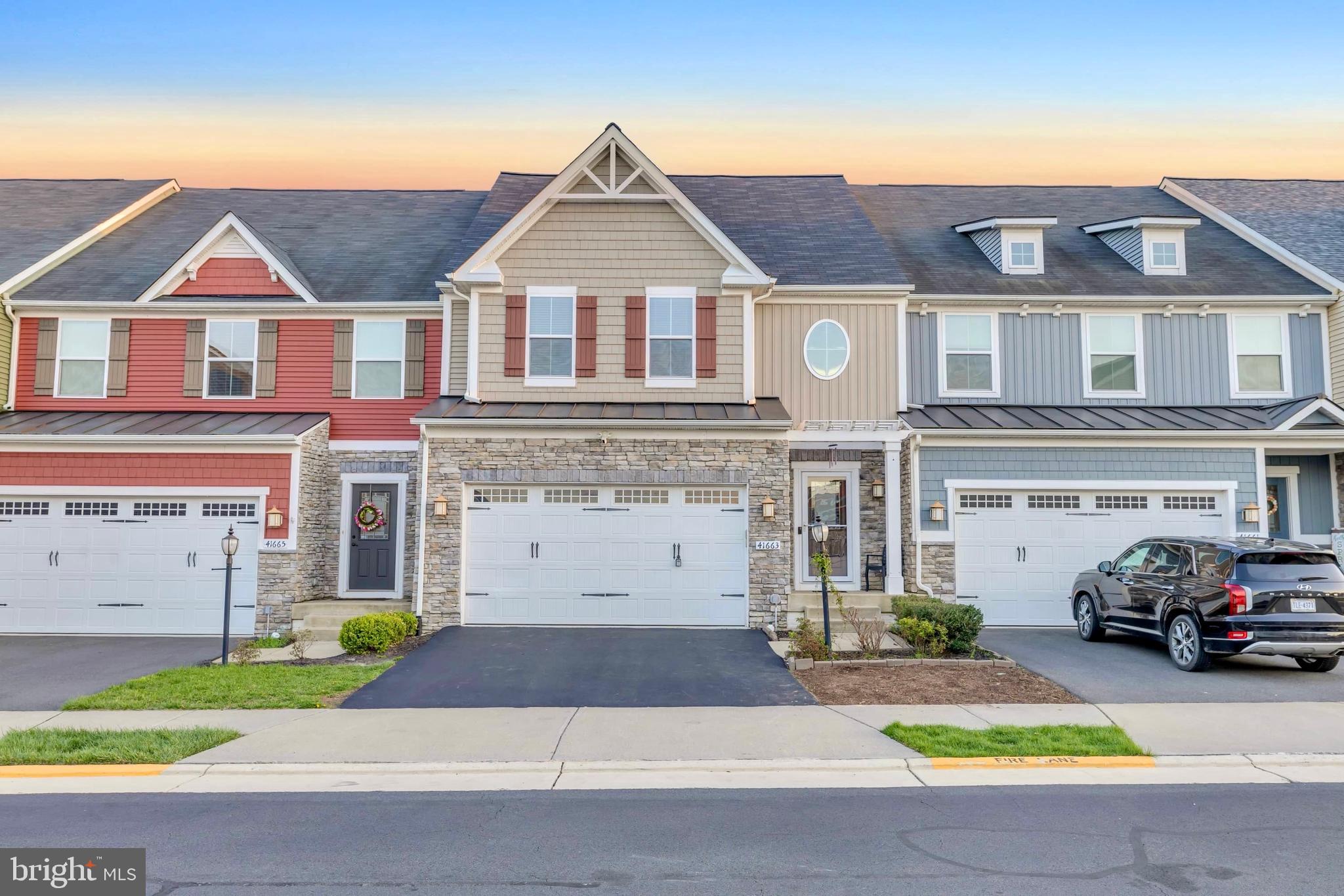 41663 McMonagle Square Aldie, VA 20105 - Photo 42 of 50 a front view of a house with a garden and parking
