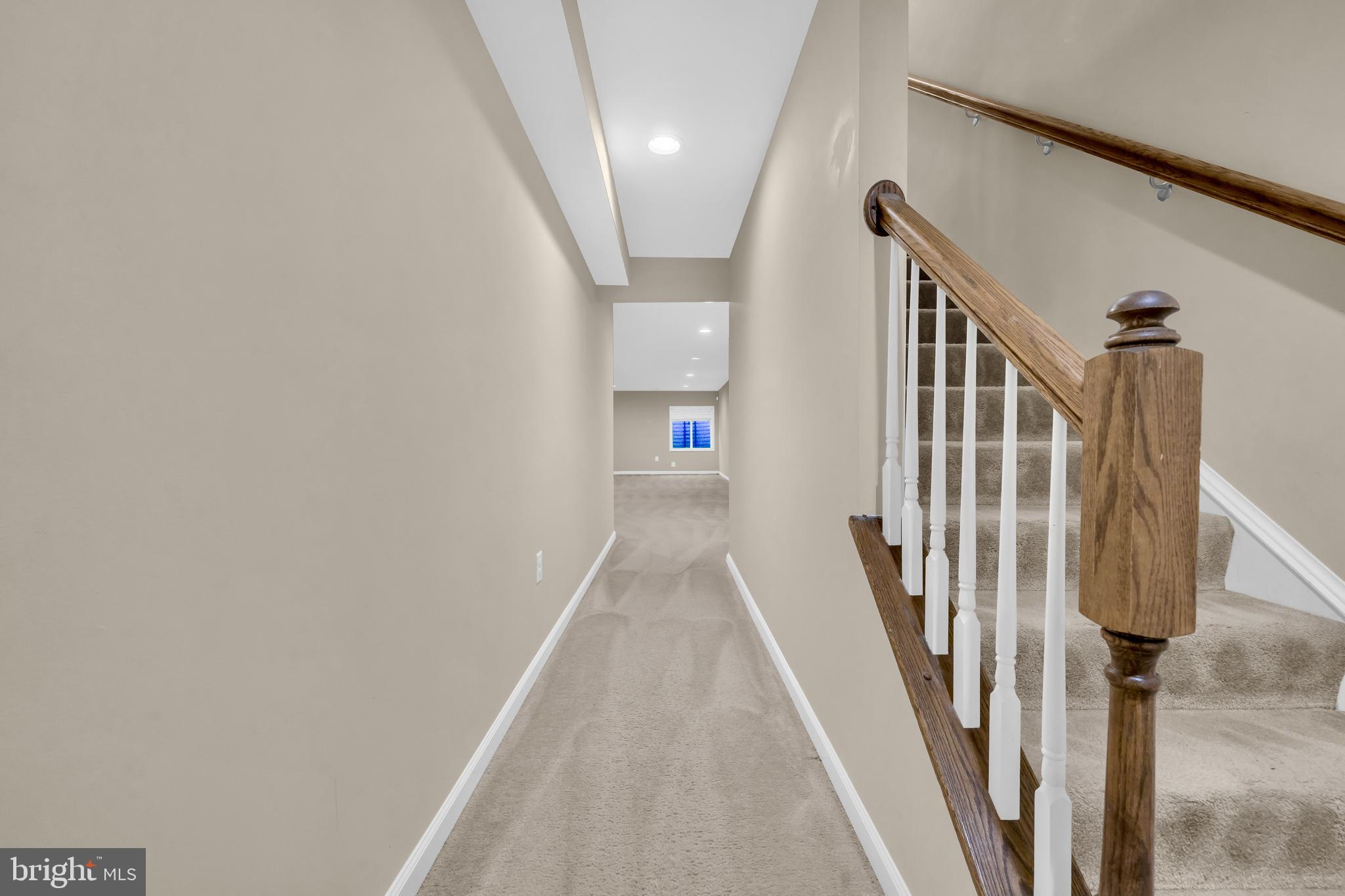 41663 McMonagle Square Aldie, VA 20105 - Photo 5 of 50 a view of a hallway with wooden floor and staircase