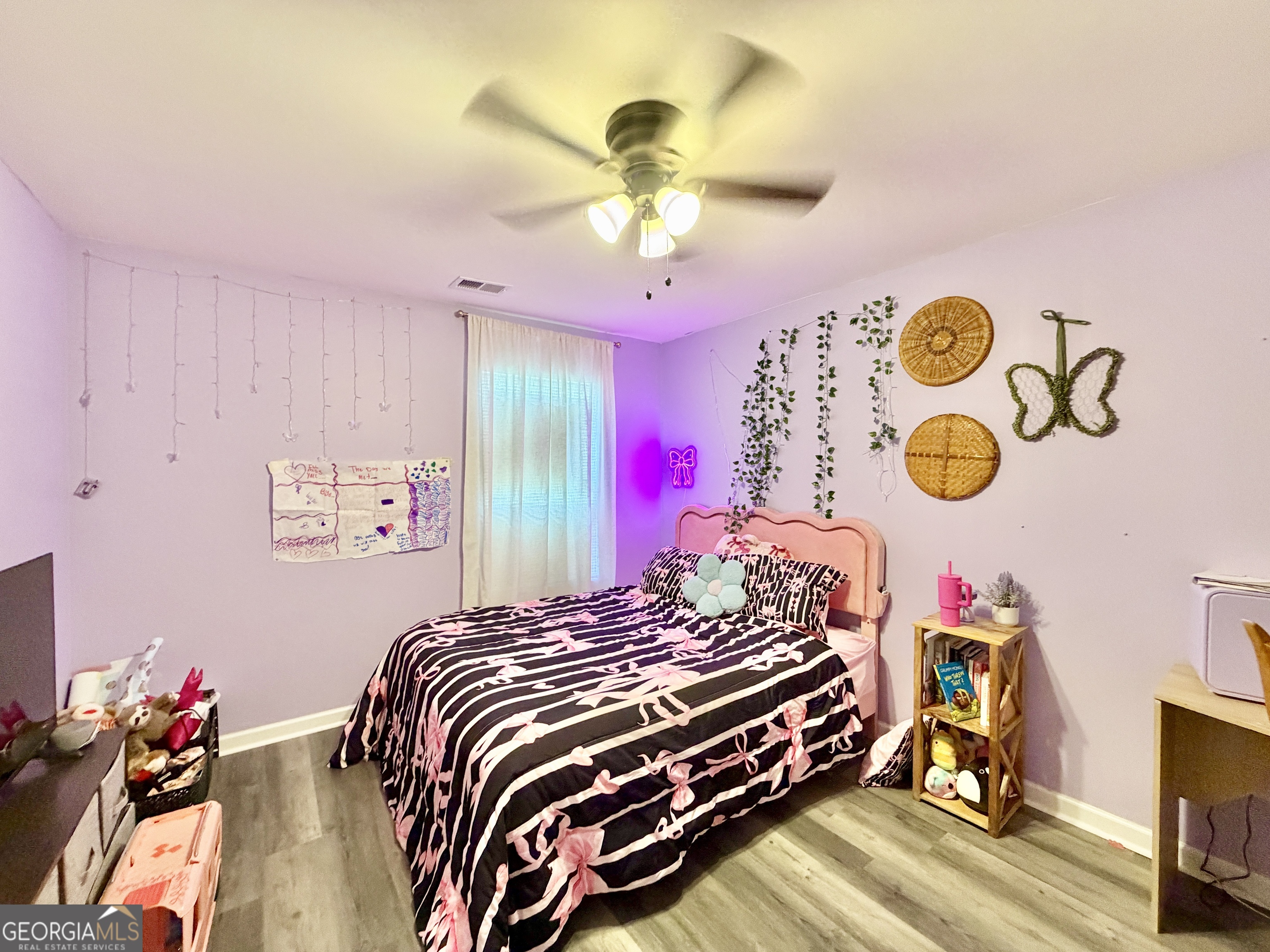 219 Barnyard Way Perry, GA 31069 - Photo 30 of 44 a bedroom with a bed and a chandelier