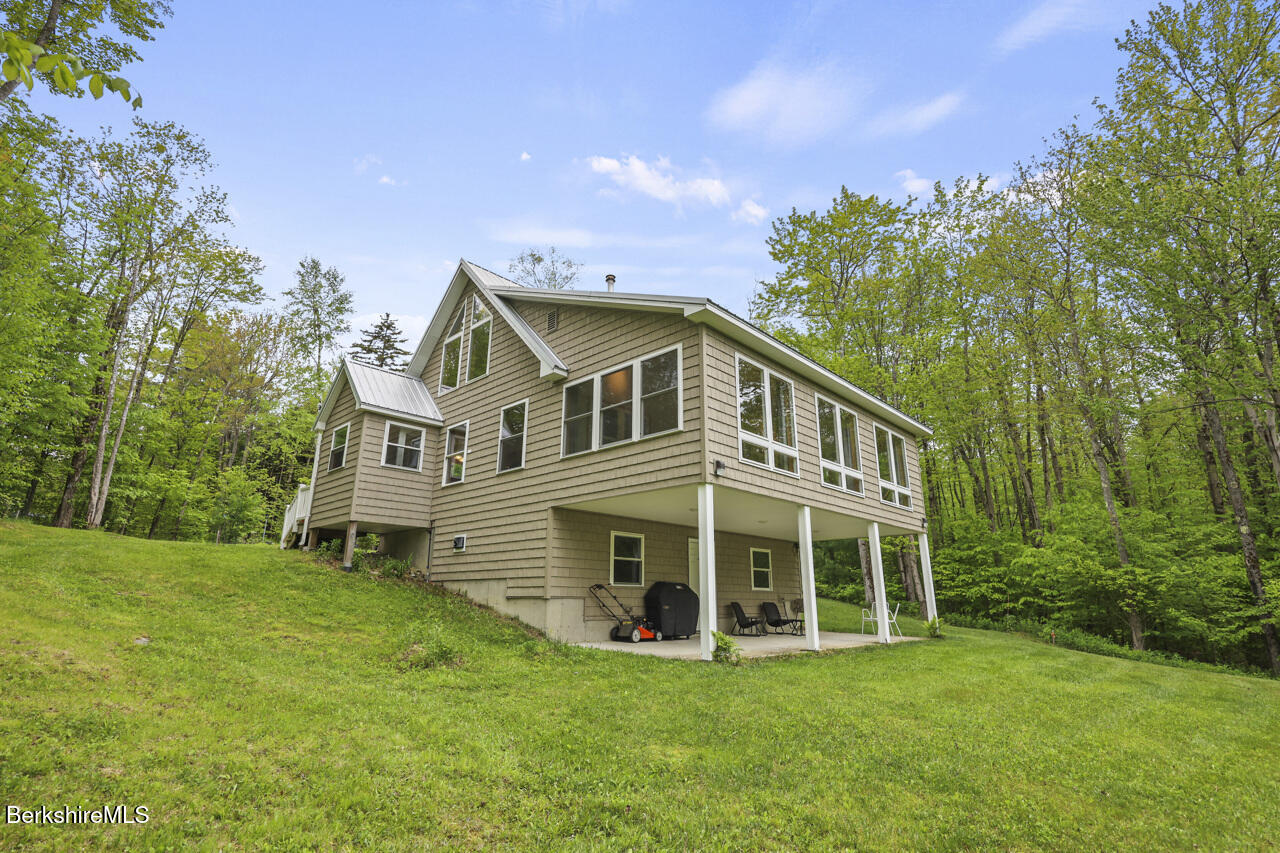 486 New State Road Savoy, MA 01256 - Photo 40 of 53 a view of a house with a big yard and large trees