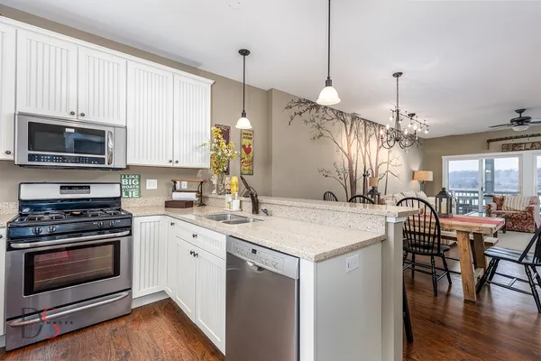 a kitchen with a stove a sink and a refrigerator