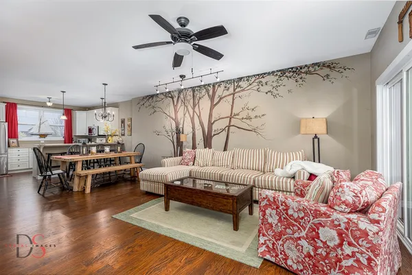 a living room with furniture and a wooden floor