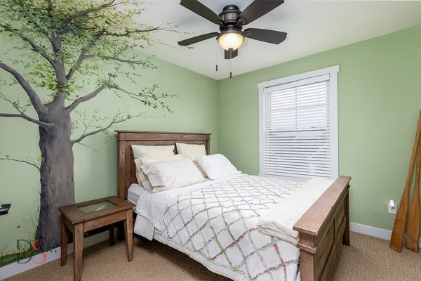 a bedroom with a bed and a chandelier