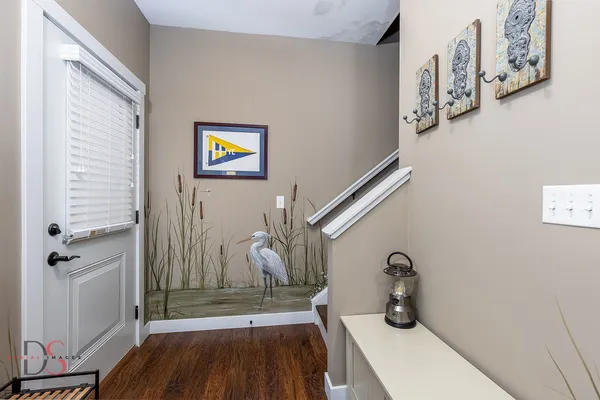 a view of an entryway with wooden floor