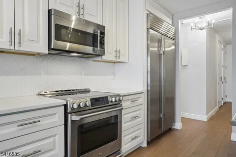 a kitchen with stainless steel appliances a stove a microwave and cabinets