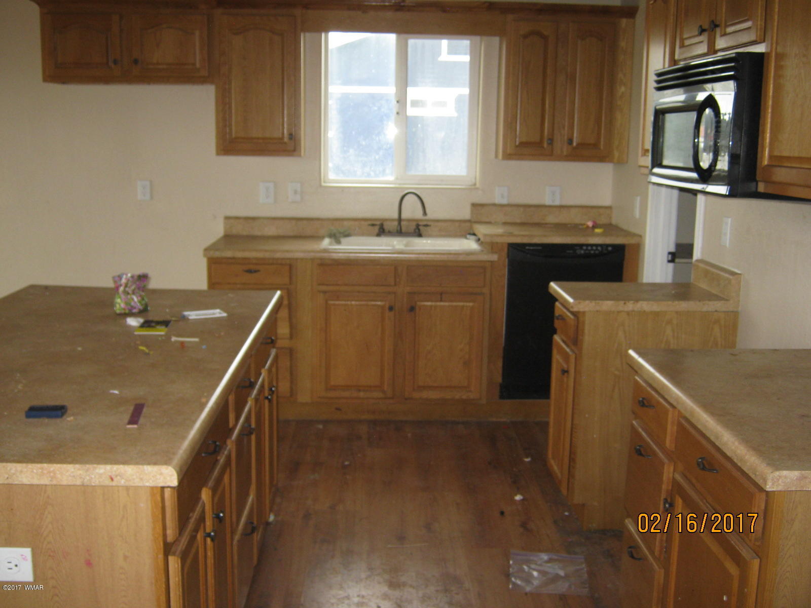 438 North Butler Street Eagar, AZ 85925 - Photo 2 of 8 a kitchen with a sink stove and cabinets