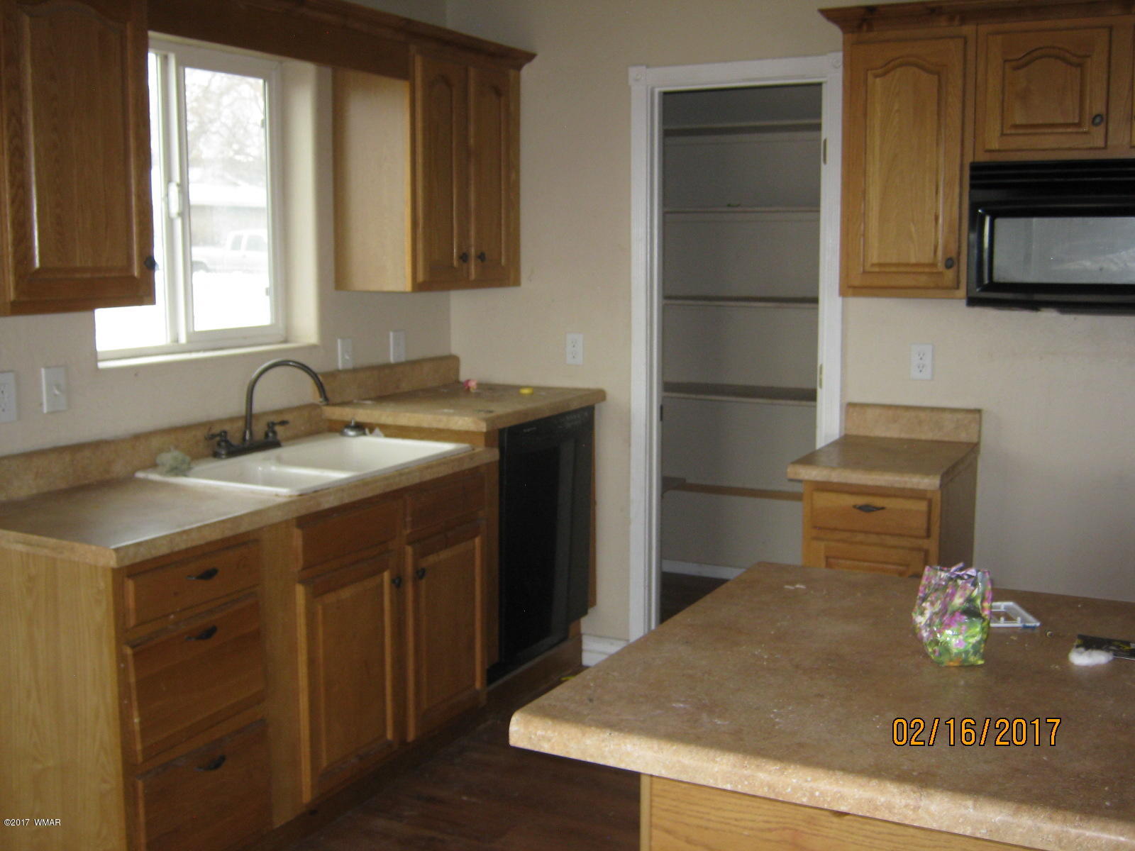 438 North Butler Street Eagar, AZ 85925 - Photo 3 of 8 a kitchen with a sink refrigerator and microwave
