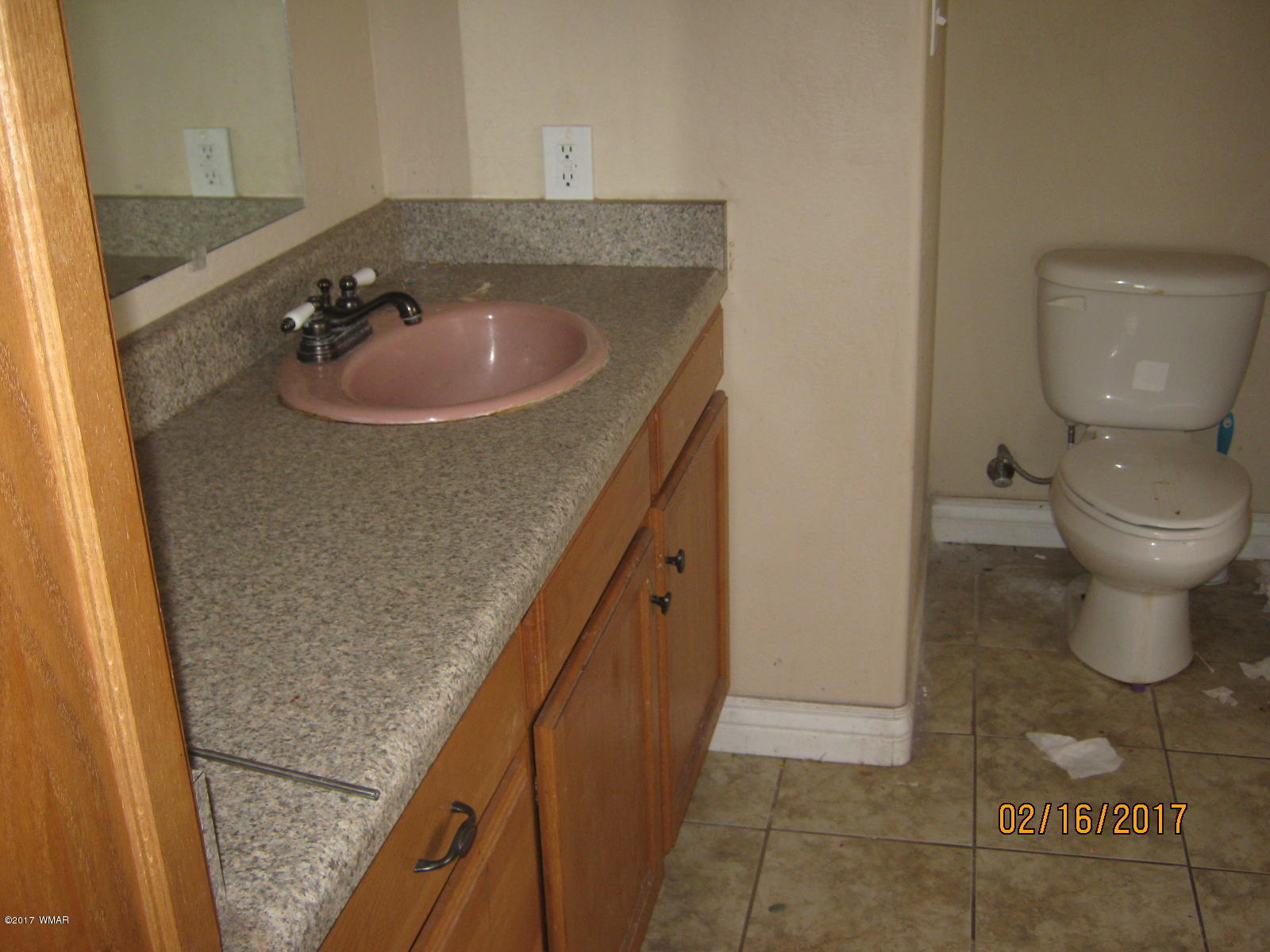 438 North Butler Street Eagar, AZ 85925 - Photo 4 of 8 a bathroom with a sink a toilet and a mirror