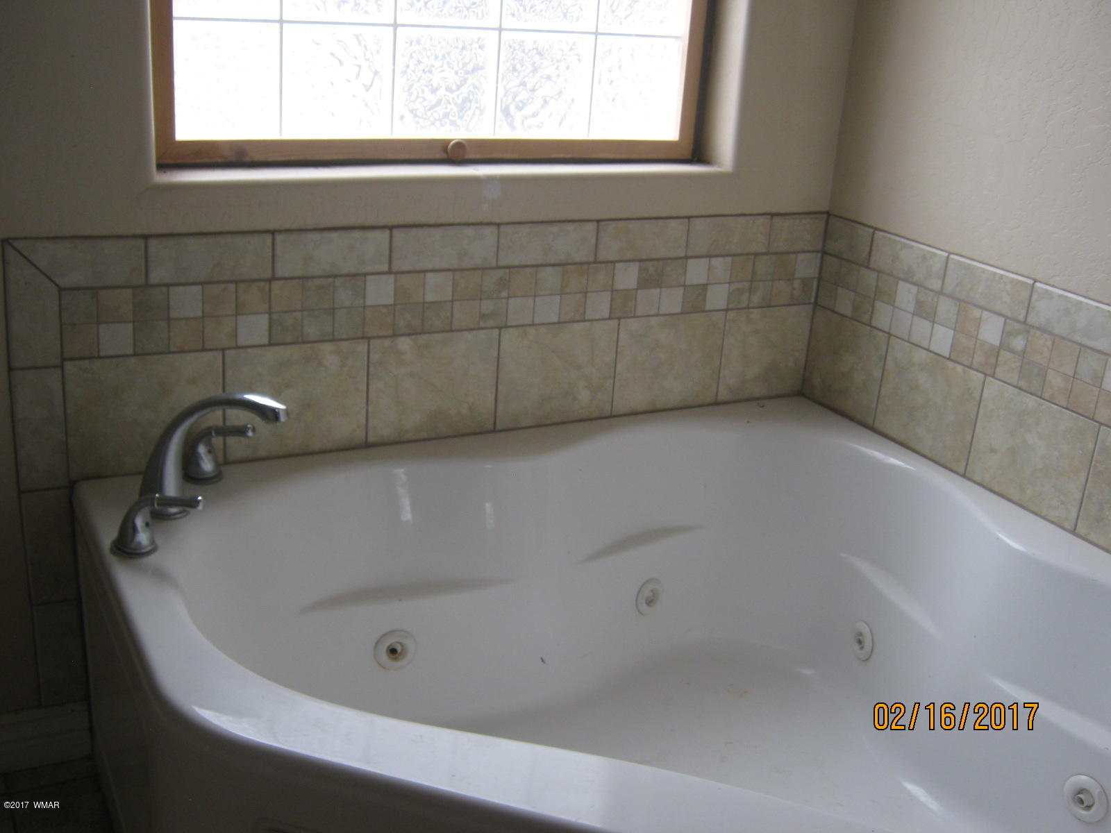 438 North Butler Street Eagar, AZ 85925 - Photo 5 of 8 a bath tub sitting in a bathroom next to a window