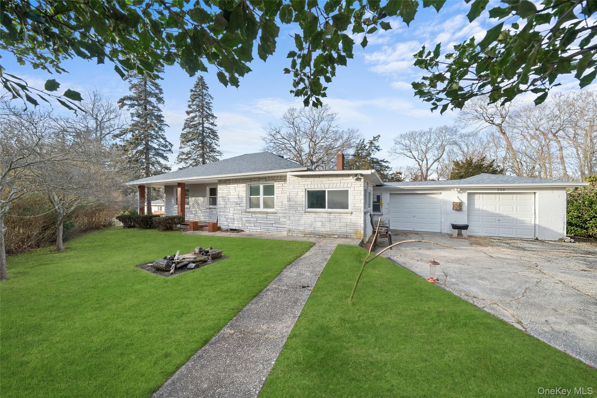 200 North Side Road Wading River, NY 11792 - Photo 20 of 30 a front view of a house with a garden and yard