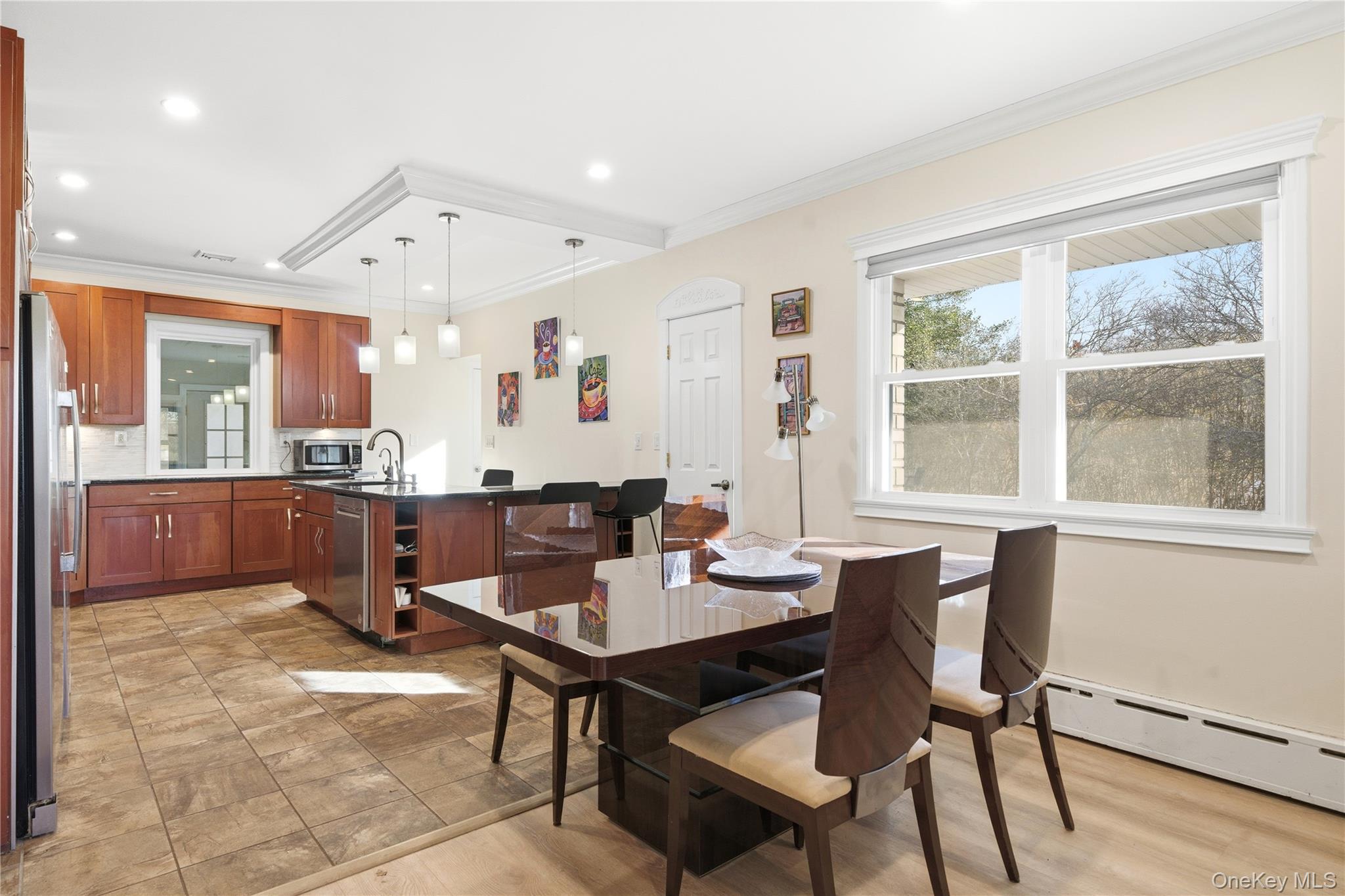 200 North Side Road Wading River, NY 11792 - Photo 7 of 30 a kitchen with a dining table chairs and large window
